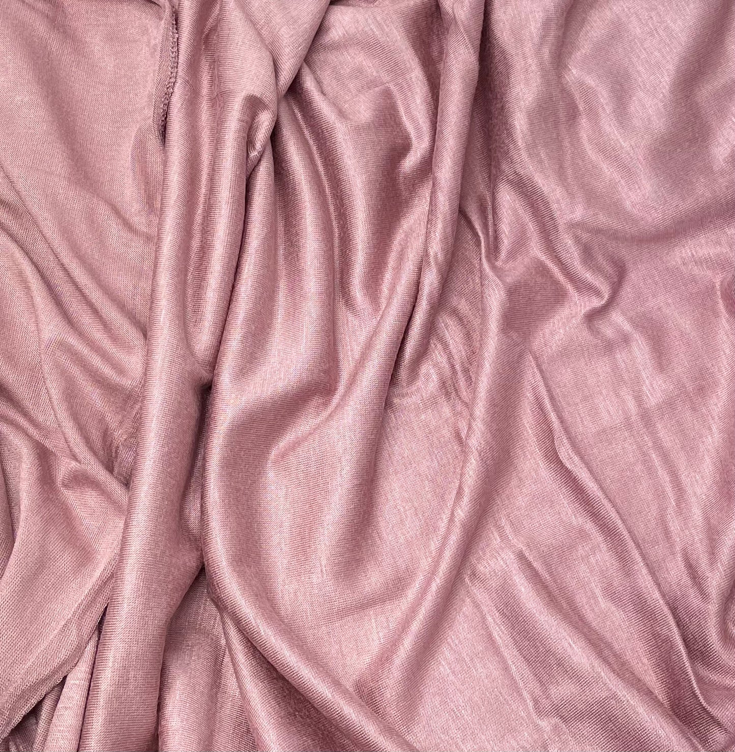 A close-up of a pink premium jersey fabric with a smooth texture.