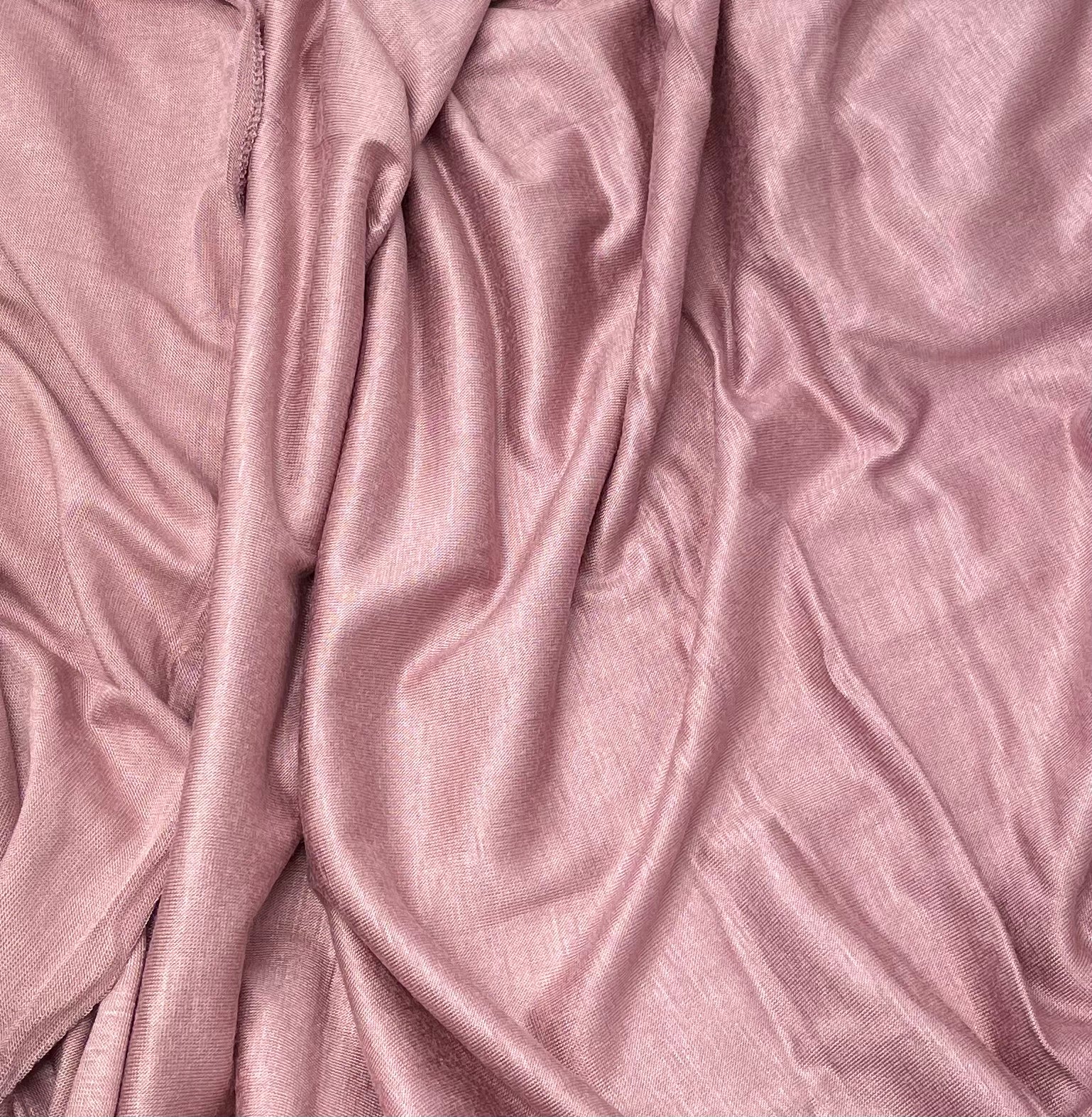 A close-up of a pink premium jersey fabric with a smooth texture.