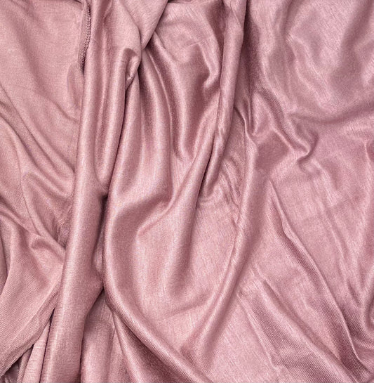 A close-up of a pink premium jersey fabric with a smooth texture.